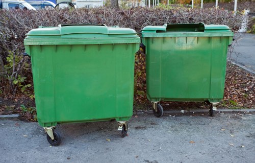Street-level commercial waste collection in Brockley, showing recycling bins and storefronts
